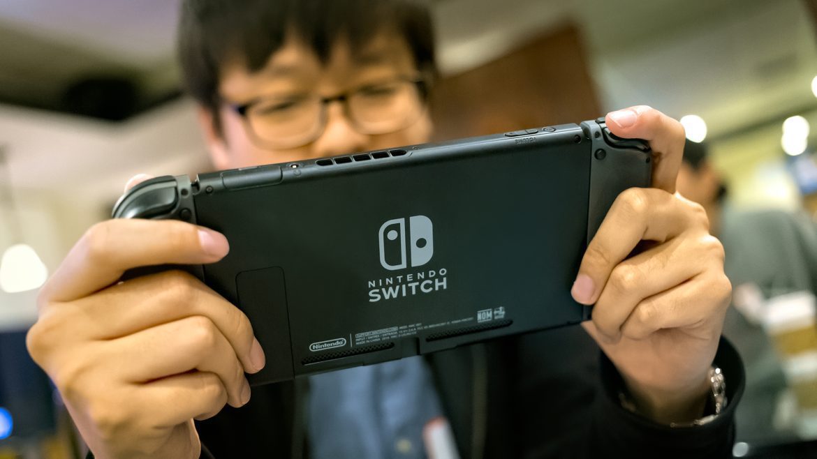 Gamer With Nintendo Switch At Cafe